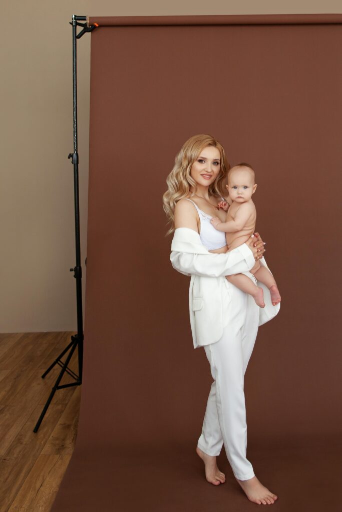 a new mom holding her newborn for a photoshoot