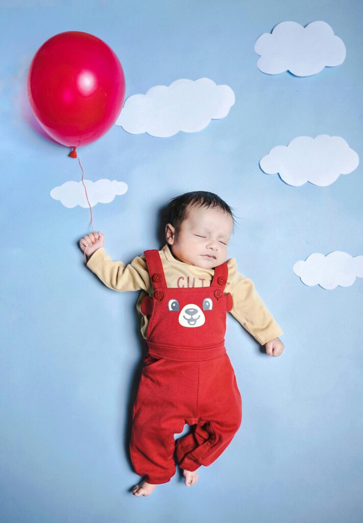 a sleeping newborn baby posed for a cute photoshoot